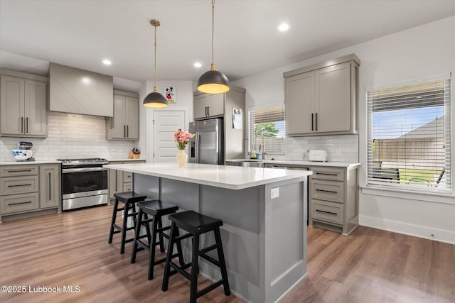 4724 121st Pl, Lubbock, TX 79424 - kitchen with stainless steel appliances, gray cabinets, a breakfast bar area, and recessed lighting