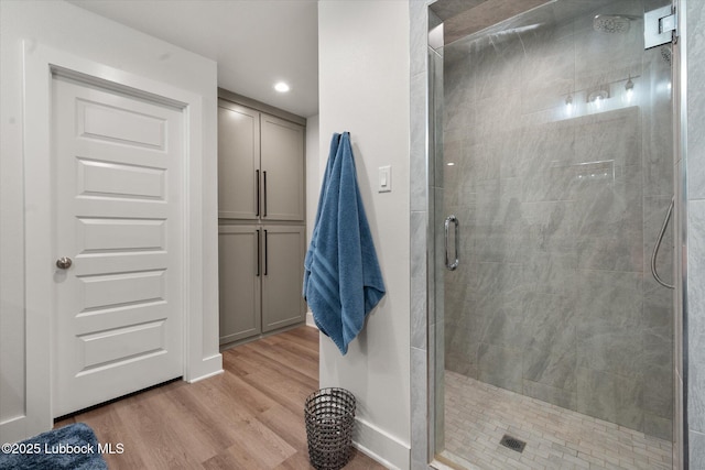 4724 121st Pl, Lubbock, TX 79424 - bathroom featuring wood finished floors, a shower stall, baseboards, and recessed lighting