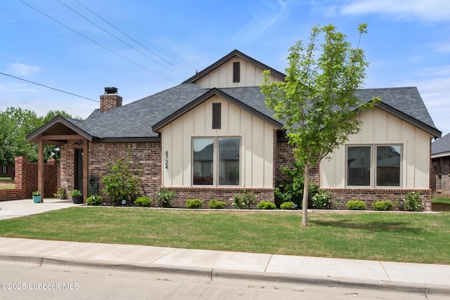 4724 121st Pl, Lubbock, TX 79424 - view of front facade with board and batten siding, brick siding, a front lawn, and roof with shingles
