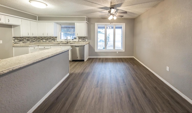 kitchen with white cabinetry, sink, backsplash, stainless steel dishwasher, and dark wood-type flooring