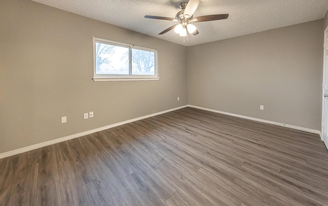 spare room featuring ceiling fan, dark hardwood / wood-style floors, and a textured ceiling