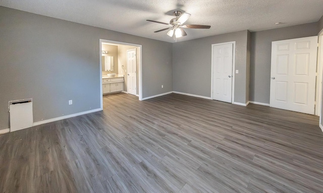 unfurnished bedroom with connected bathroom, ceiling fan, hardwood / wood-style flooring, and a textured ceiling