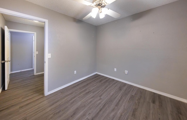 unfurnished room featuring ceiling fan, dark hardwood / wood-style floors, and a textured ceiling