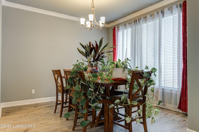 136 Preston Hollow Ln, Wolfforth, TX 79382 - dining room featuring ornamental molding, plenty of natural light, a chandelier, and wood finished floors