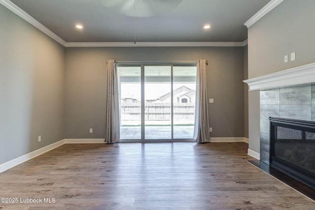 136 Preston Hollow Ln, Wolfforth, TX 79382 - unfurnished living room with crown molding, wood finished floors, a tile fireplace, recessed lighting, and a ceiling fan