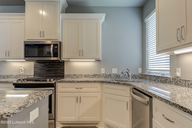 136 Preston Hollow Ln, Wolfforth, TX 79382 - kitchen featuring stainless steel appliances, white cabinets, and light stone countertops