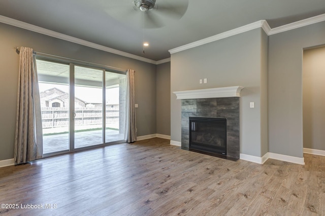 136 Preston Hollow Ln, Wolfforth, TX 79382 - unfurnished living room with a ceiling fan, wood finished floors, a tile fireplace, and crown molding