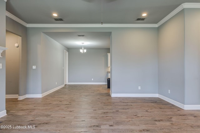 136 Preston Hollow Ln, Wolfforth, TX 79382 - empty room with crown molding, wood finished floors, recessed lighting, and a chandelier