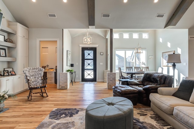 living room with light hardwood / wood-style flooring and lofted ceiling with beams