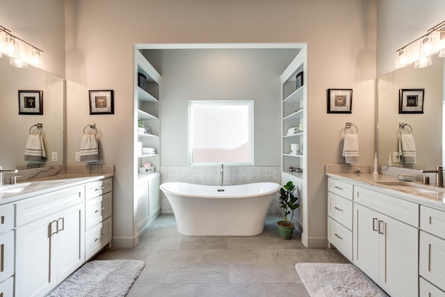 bathroom featuring vanity and a tub