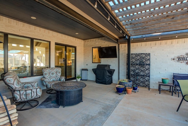 view of patio / terrace with a pergola and a fire pit