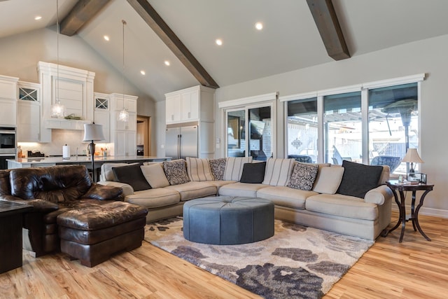 living room featuring beamed ceiling, high vaulted ceiling, and light wood-type flooring