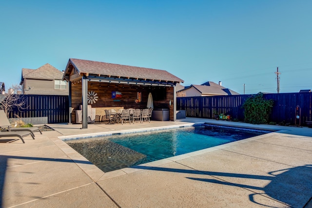 view of swimming pool with an outbuilding and a patio area