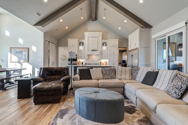 living room featuring sink, high vaulted ceiling, light hardwood / wood-style floors, and beamed ceiling