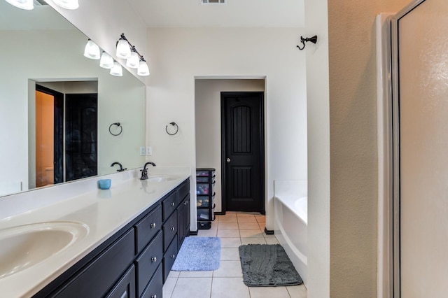 bathroom featuring vanity, a bathtub, and tile patterned floors