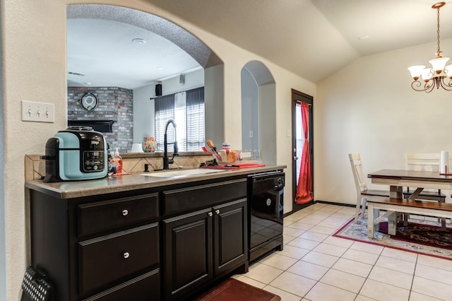 kitchen featuring lofted ceiling, sink, light tile patterned floors, black dishwasher, and pendant lighting