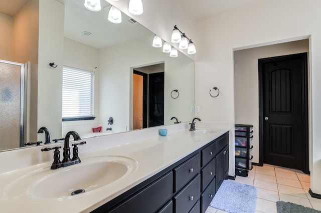 bathroom featuring tile patterned flooring, vanity, and a shower with door