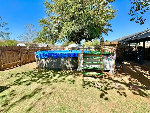 view of yard with a covered pool