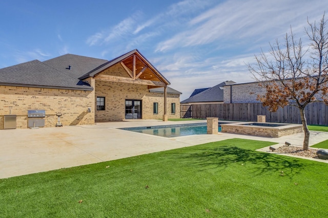 view of swimming pool featuring a fenced backyard, a fenced in pool, area for grilling, and an in ground hot tub