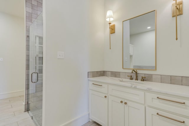 full bathroom with tile patterned flooring, a shower stall, vanity, and baseboards