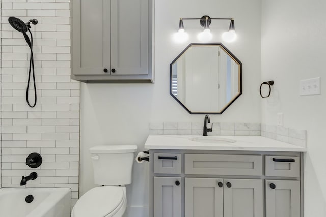 bathroom featuring toilet,  shower combination, and vanity