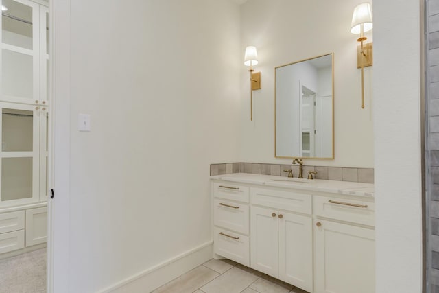 full bath featuring vanity, baseboards, and tile patterned floors