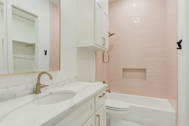 bathroom with a spacious closet, bathing tub / shower combination, toilet, and vanity