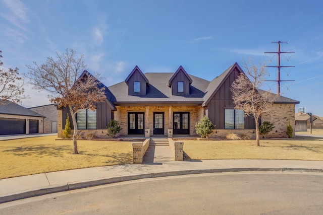 view of front of home featuring board and batten siding, brick siding, and a garage