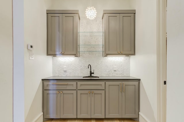 kitchen with a sink and gray cabinetry