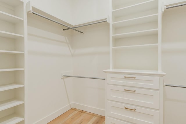 walk in closet featuring light wood finished floors