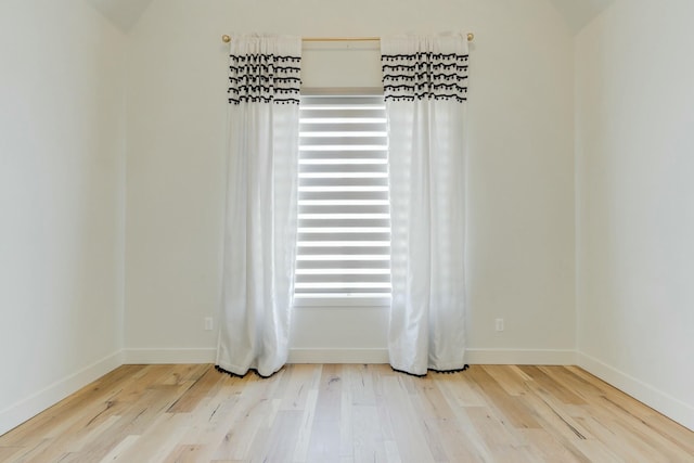 room details featuring baseboards and wood finished floors