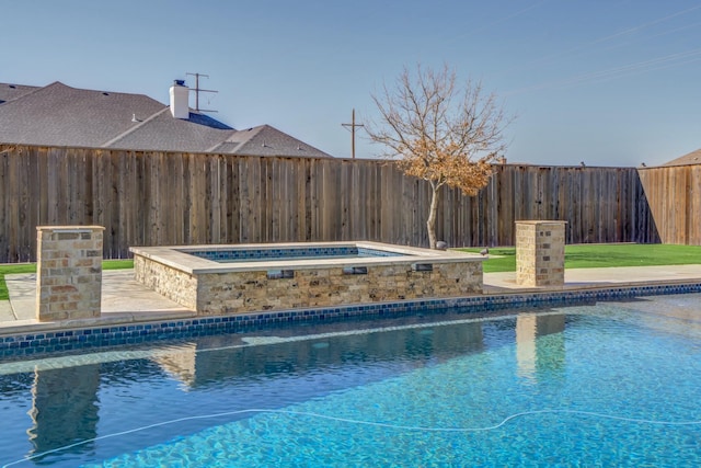 view of pool with a fenced backyard, a fenced in pool, and an in ground hot tub