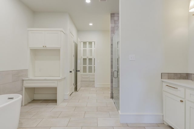 full bathroom featuring recessed lighting, a soaking tub, visible vents, a stall shower, and vanity