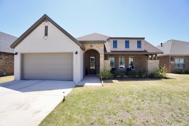 view of front of house featuring an attached garage, concrete driveway, a front lawn, and stucco siding