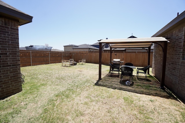 view of yard featuring a gazebo and a fenced backyard