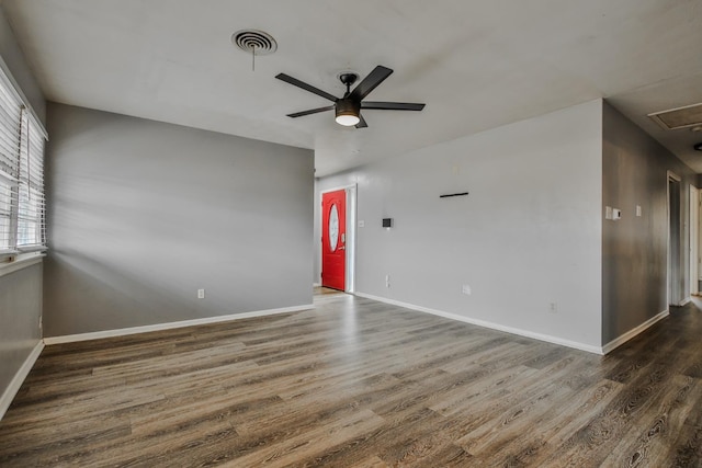 spare room with dark hardwood / wood-style floors and ceiling fan