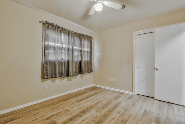 spare room featuring light hardwood / wood-style flooring and ceiling fan