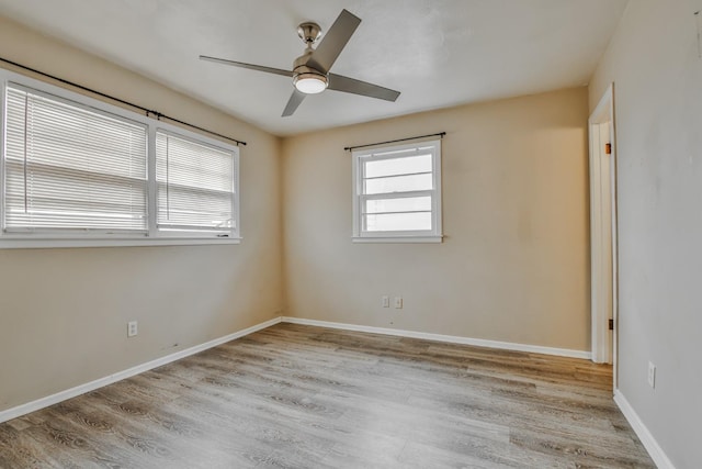 spare room with light hardwood / wood-style flooring and ceiling fan