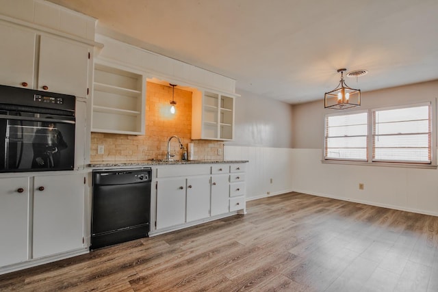 kitchen featuring sink, light hardwood / wood-style flooring, hanging light fixtures, black appliances, and white cabinets