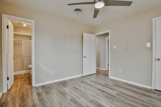 unfurnished bedroom featuring light hardwood / wood-style flooring, ceiling fan, and ensuite bathroom