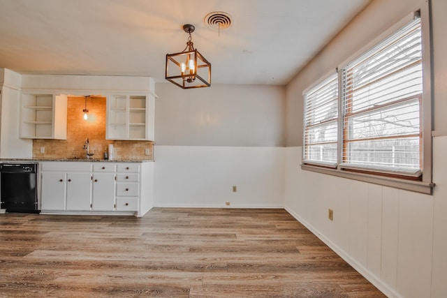 kitchen with dishwasher, white cabinetry, light stone countertops, decorative light fixtures, and light wood-type flooring