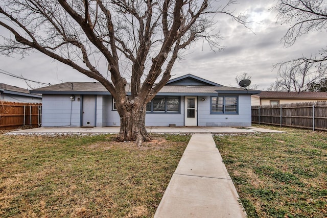 view of front of house with a patio and a front lawn