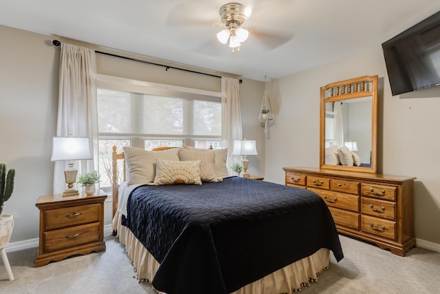 bedroom with baseboards, a ceiling fan, and light colored carpet