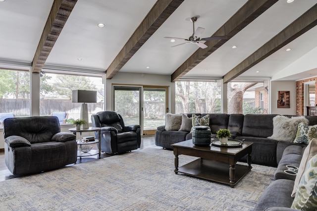 living area featuring recessed lighting, ceiling fan, beam ceiling, and plenty of natural light