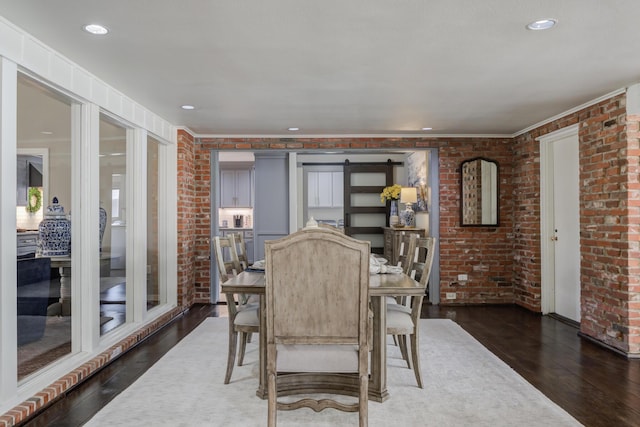 dining room with dark wood-style flooring and brick wall