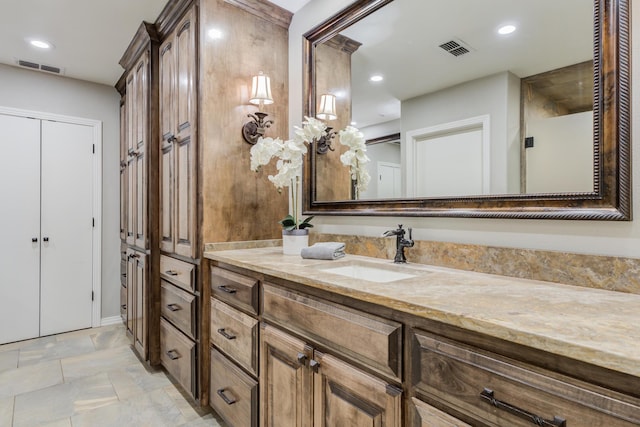bathroom with visible vents, vanity, and recessed lighting