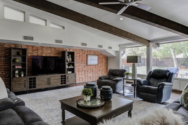 living room with visible vents, a ceiling fan, and beamed ceiling