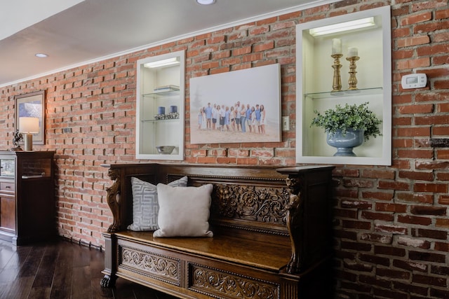 interior space featuring wood finished floors and crown molding