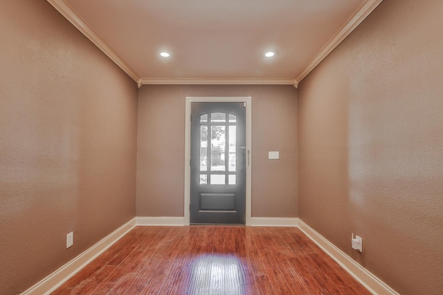 entryway with hardwood / wood-style flooring and ornamental molding