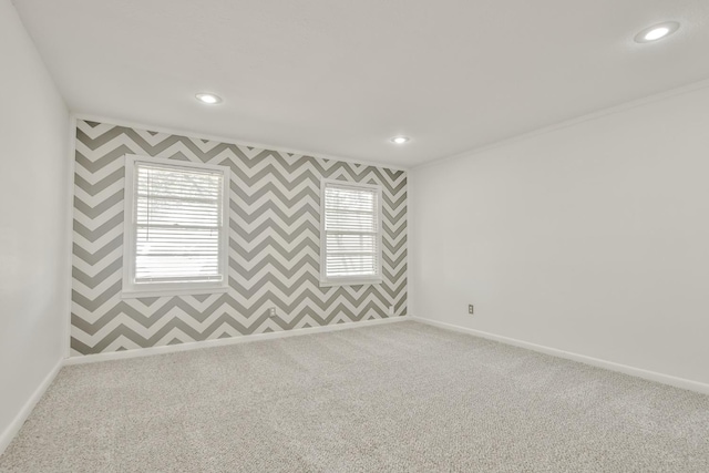 carpeted spare room with crown molding